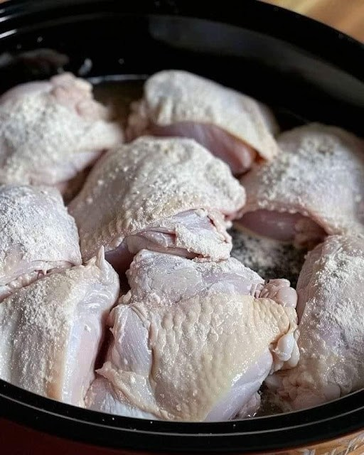 Coat chicken with flour, then place in a slow cooker. Just four additional items will make for a great meal.