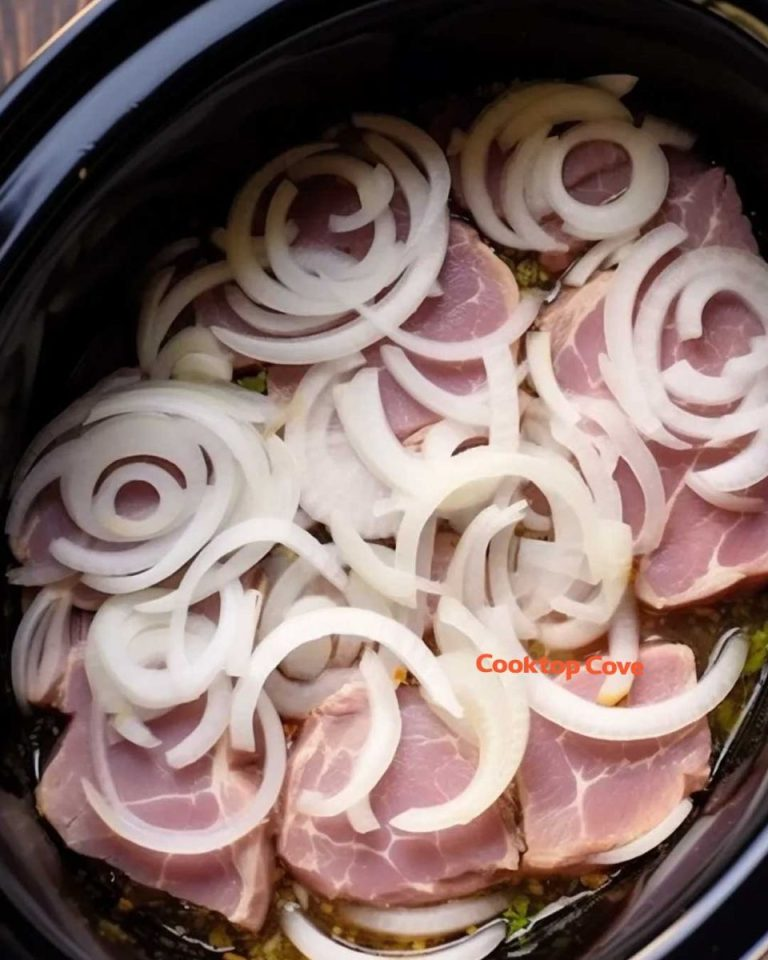 Place sliced onions over pork chops in slow cooker & get the tastiest meal in no time